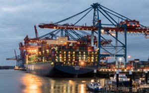 Container ships moored at Terminal Burchardkai in Hamburg, Germany during evening hours.