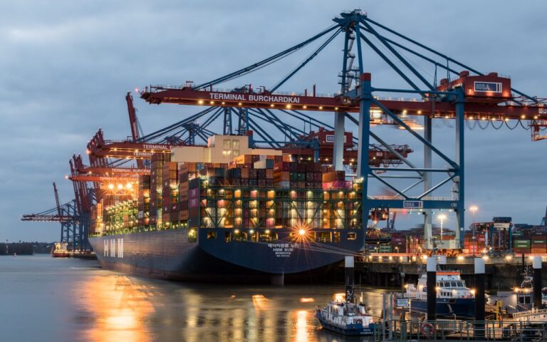 Container ships moored at Terminal Burchardkai in Hamburg, Germany during evening hours.
